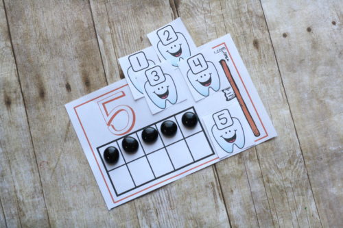 Practice math and good dental health with these adorable tooth counting mats. Count, add, compare, and more with these free printables!